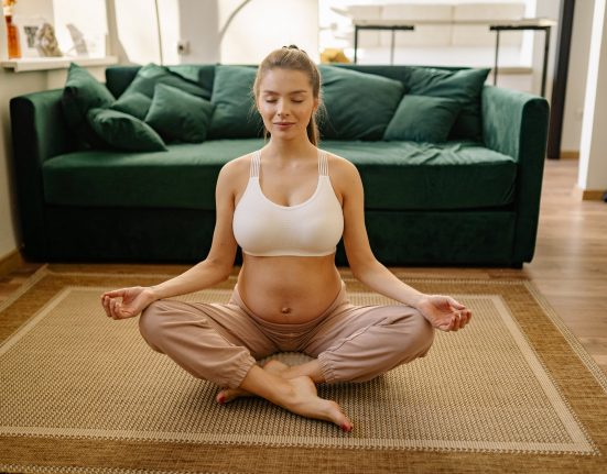 a pregnant woman doing meditation