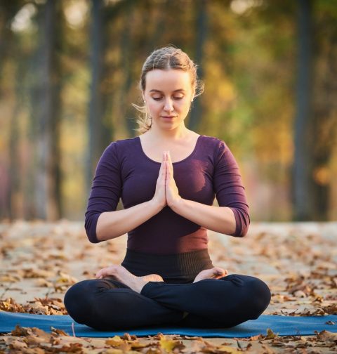 Beautiful young woman meditates in yoga asana