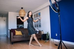 Young Indian woman blogger dancing for video for social media streaming broadcasting on Internet