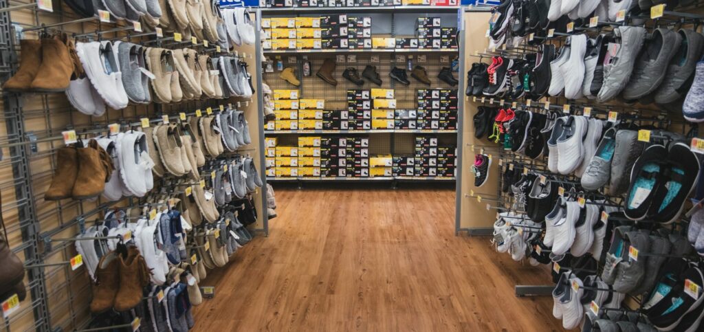 Shoe aisle in store, lots of shoes on racks
