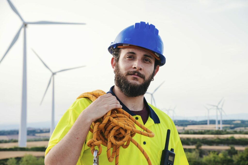 Technician or engineer of wind mill turbine and renewable energy professional standing looking at