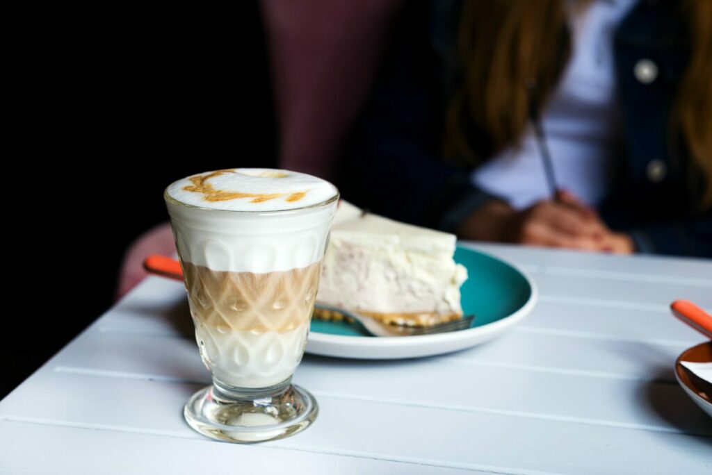 Glass of Latte macchiato with rich milk foam in cafe