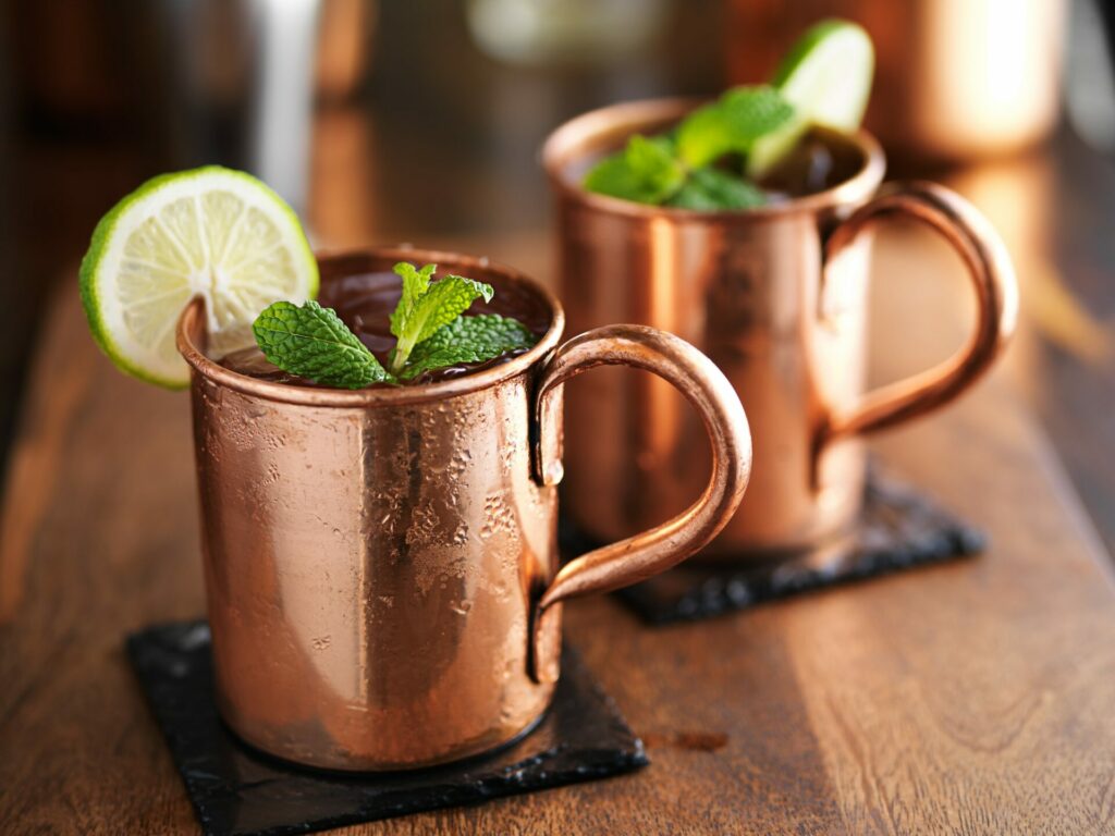 moscow mules in copper cups on slate coasters