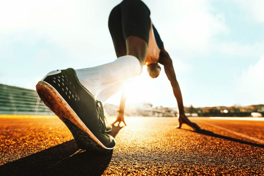 Athlete runner feet running on treadmill closeup on shoes