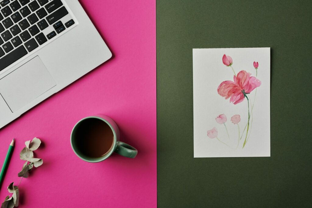 Watercolor drawing of pink flower, cup of coffee, laptop keyboard and pencil