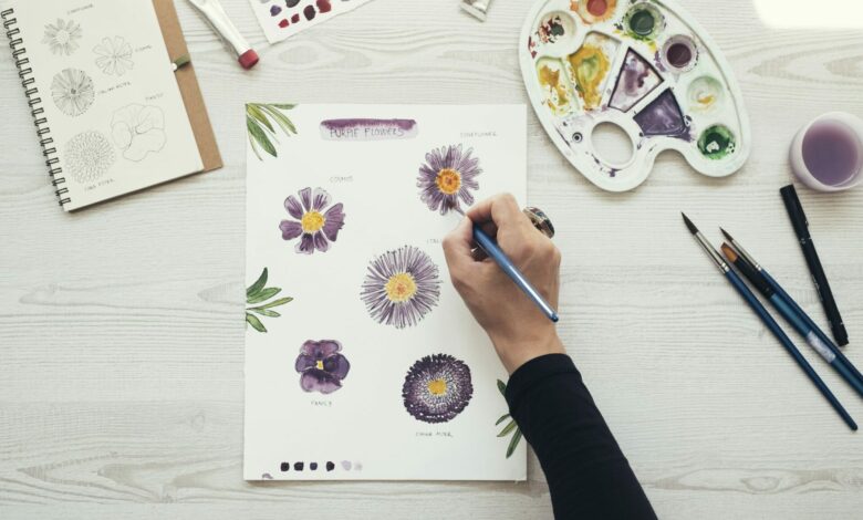 Woman making flower sketches and filling water colors