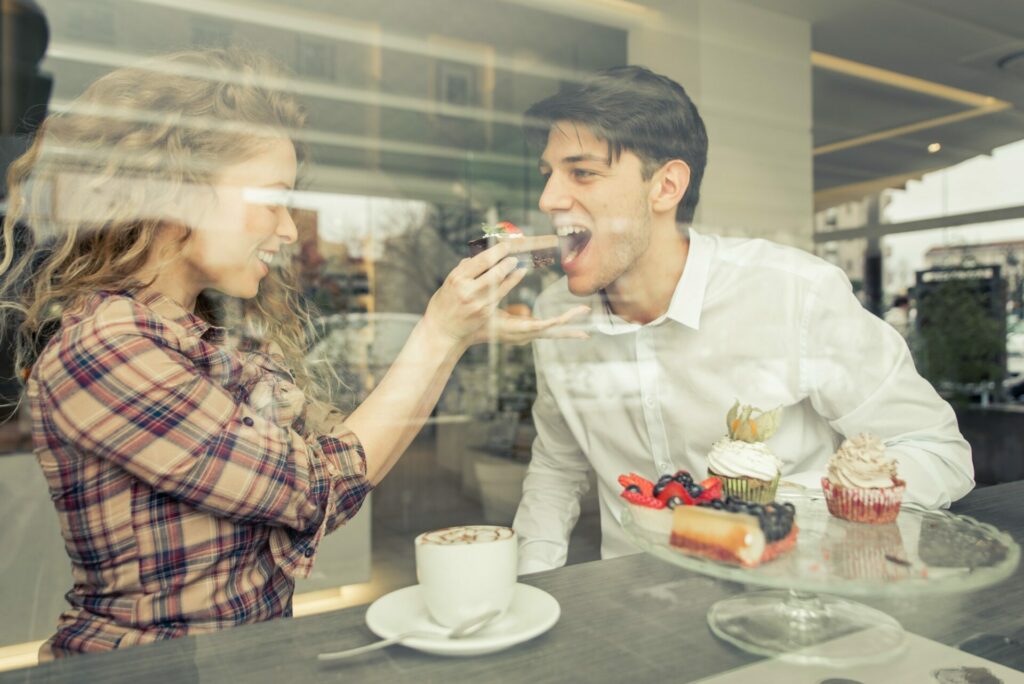 Young couple eating pastries in a pastry theme restaurant
