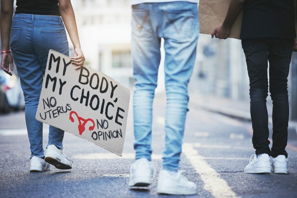 Body sign, street protest and people walking for legal justice, freedom of choice and abortion law