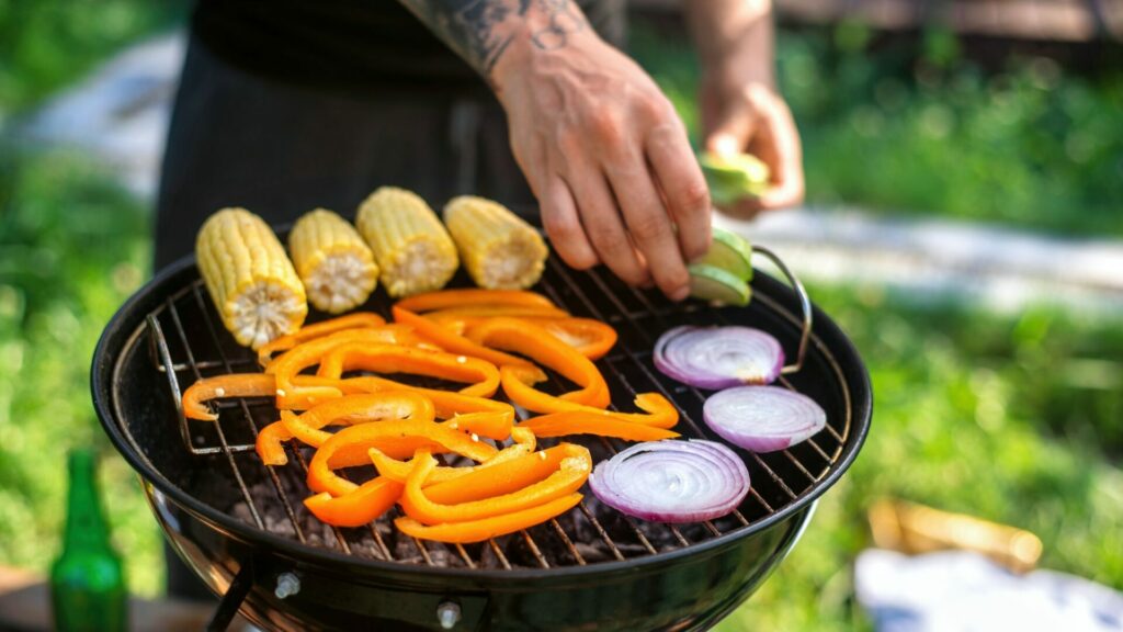 Frying vegetables on a grill at glamping