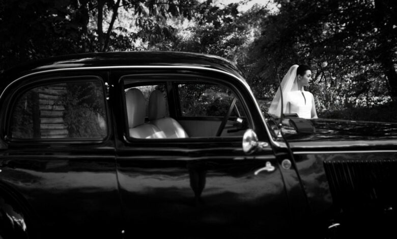 Gorgeous bride on background of stylish black car