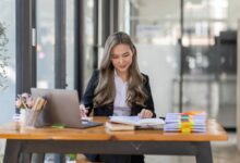 business Asian woman or accountant Bookkeeper working on calculator to calculate business data,