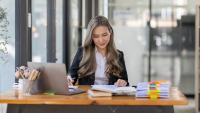 business Asian woman or accountant Bookkeeper working on calculator to calculate business data,