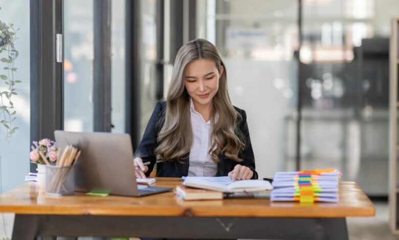 business Asian woman or accountant Bookkeeper working on calculator to calculate business data,